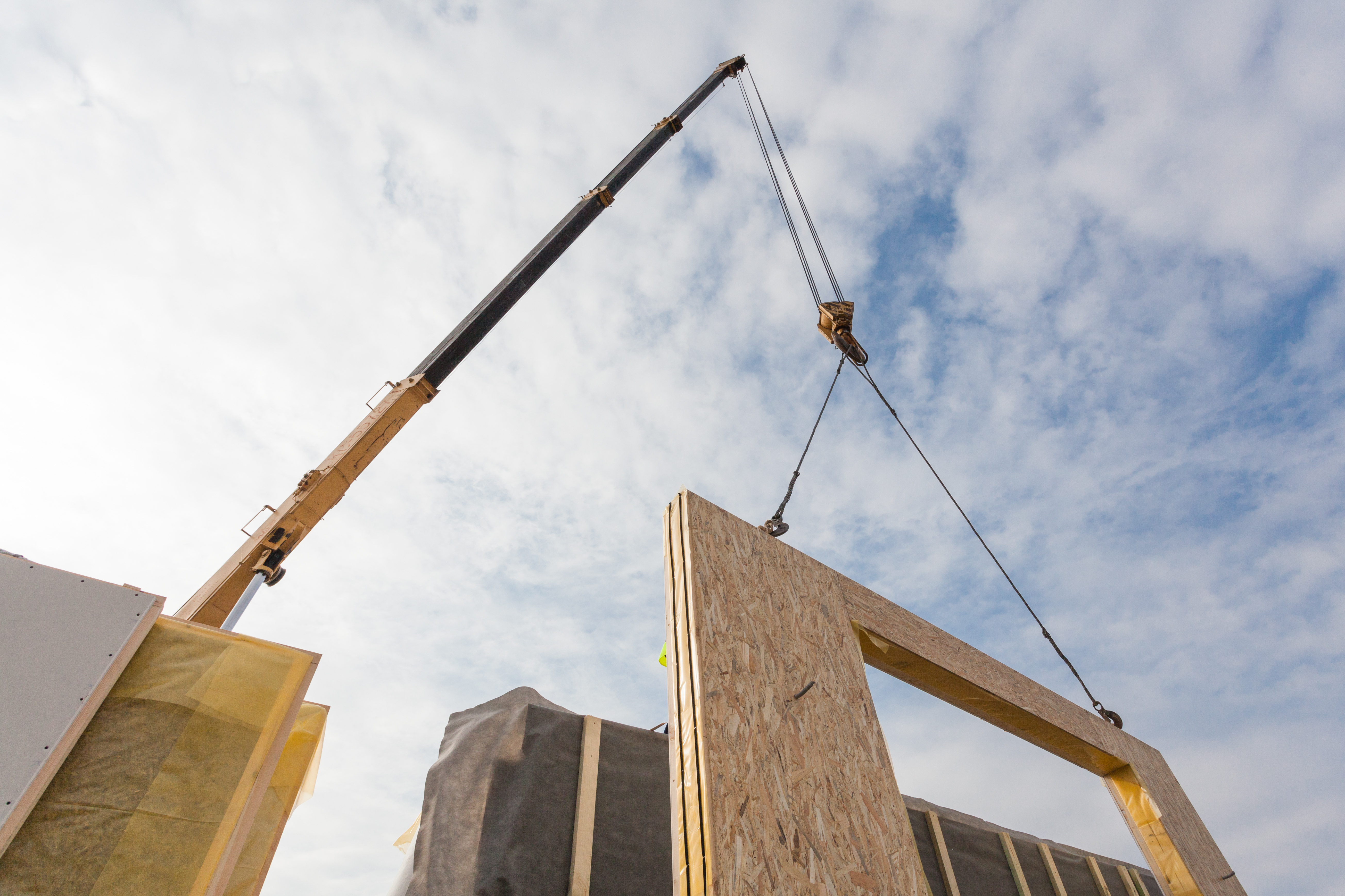 Crane installing structural panels